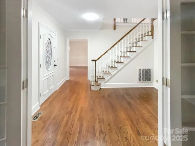 a view of entryway and hall with wooden floor