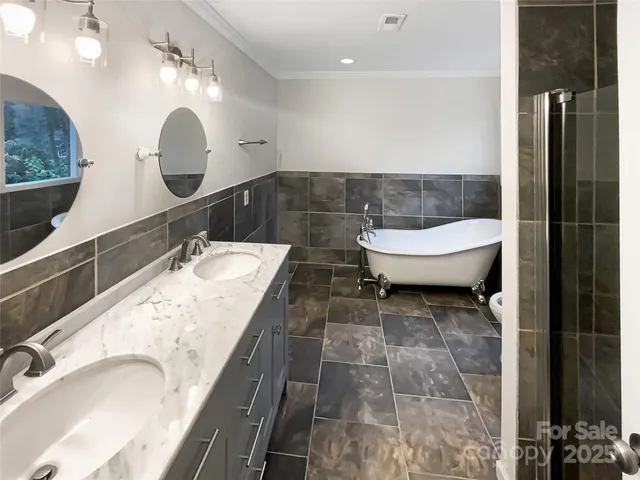 a bathroom with a granite countertop sink a toilet and bathtub