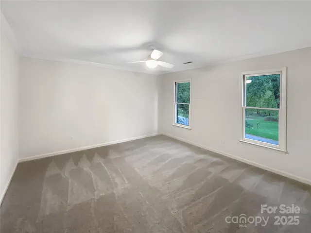 an empty room with windows and closet