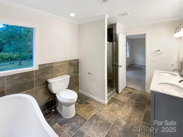 a bathroom with a toilet sink and shower