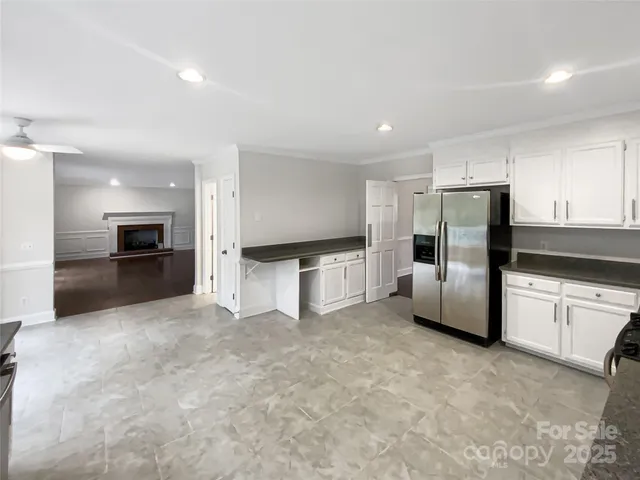 a large kitchen with a refrigerator and a stove top oven