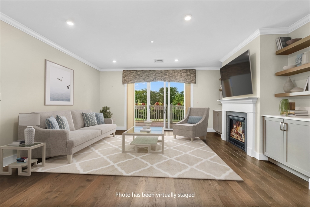 7 Longview Drive, Unit 105 Atkinson, NH 03811 - Photo 11 of 30 a living room with fireplace furniture and a flat screen tv