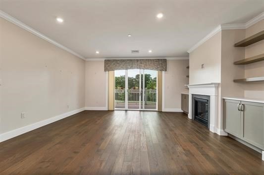 7 Longview Drive, Unit 105 Atkinson, NH 03811 - Photo 12 of 30 an empty room with wooden floor fireplace and windows
