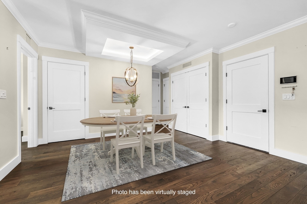 7 Longview Drive, Unit 105 Atkinson, NH 03811 - Photo 14 of 30 a view of a dining room with furniture and wooden floor