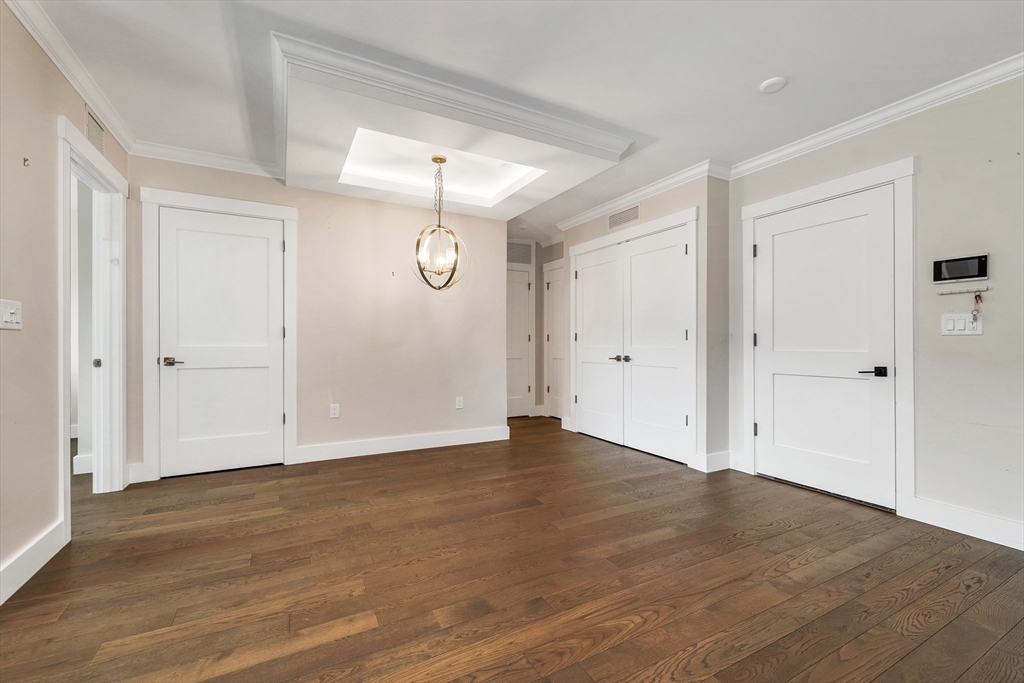 7 Longview Drive, Unit 105 Atkinson, NH 03811 - Photo 15 of 30 a view of an empty room with wooden floor