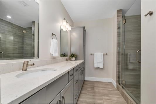 7 Longview Drive, Unit 105 Atkinson, NH 03811 - Photo 19 of 30 a bathroom with a double vanity sink and mirror