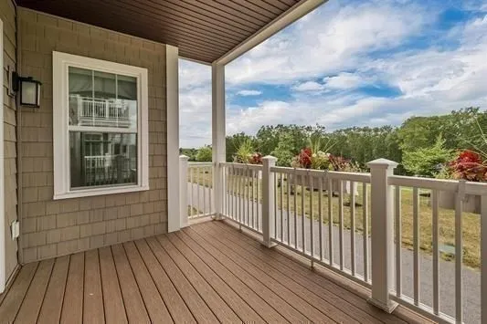 a view of a wooden deck with a yard