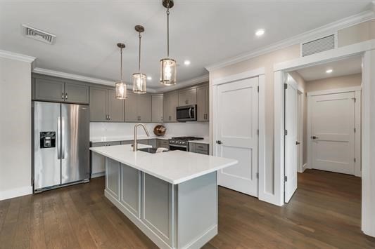 7 Longview Drive, Unit 105 Atkinson, NH 03811 - Photo 6 of 30 a kitchen with stainless steel appliances granite countertop a refrigerator a sink dishwasher a stove and white cabinets with wooden floor