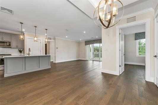 7 Longview Drive, Unit 105 Atkinson, NH 03811 - Photo 7 of 30 a view of a kitchen with a sink and a large window