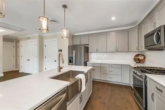 a kitchen with a stove a sink and a refrigerator