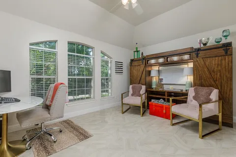 a bedroom with furniture and a flat screen tv