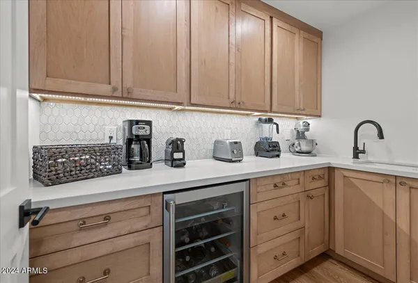 a kitchen with granite countertop white cabinets and sink