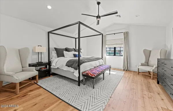 a bedroom with bed and wooden floor