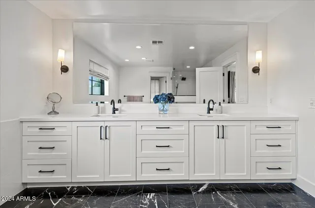 a bathroom with a sink double vanity and a mirror