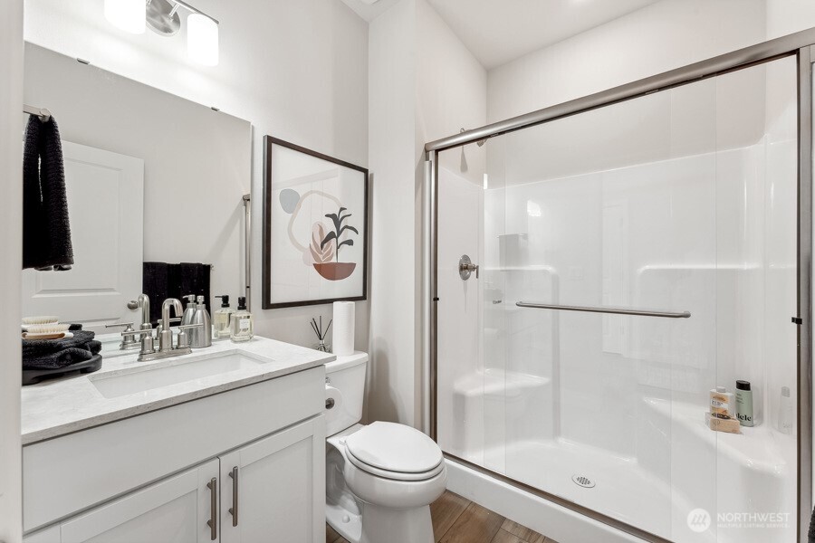 17529 Northeast Midnight Sun Loop Poulsbo, WA 98370 - Photo 16 of 36 a bathroom with a sink toilet and shower