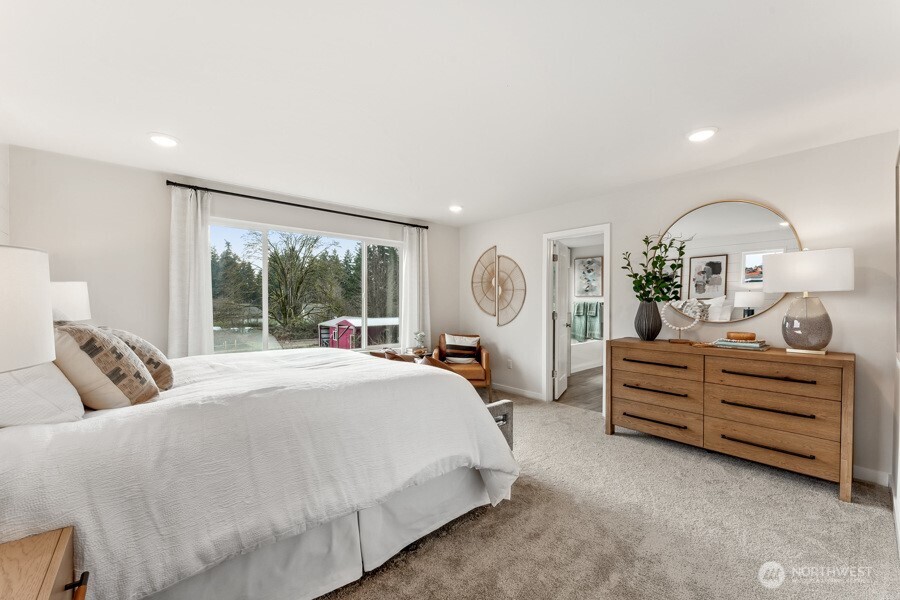 17529 Northeast Midnight Sun Loop Poulsbo, WA 98370 - Photo 26 of 36 a bed room with a bed and a large window