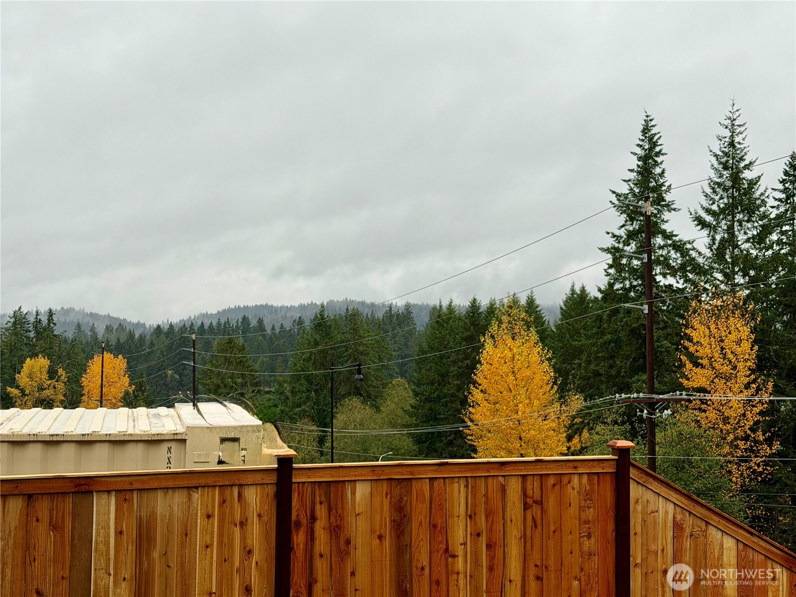 17529 Northeast Midnight Sun Loop Poulsbo, WA 98370 - Photo 34 of 36 a view of a balcony with wooden fence and floor