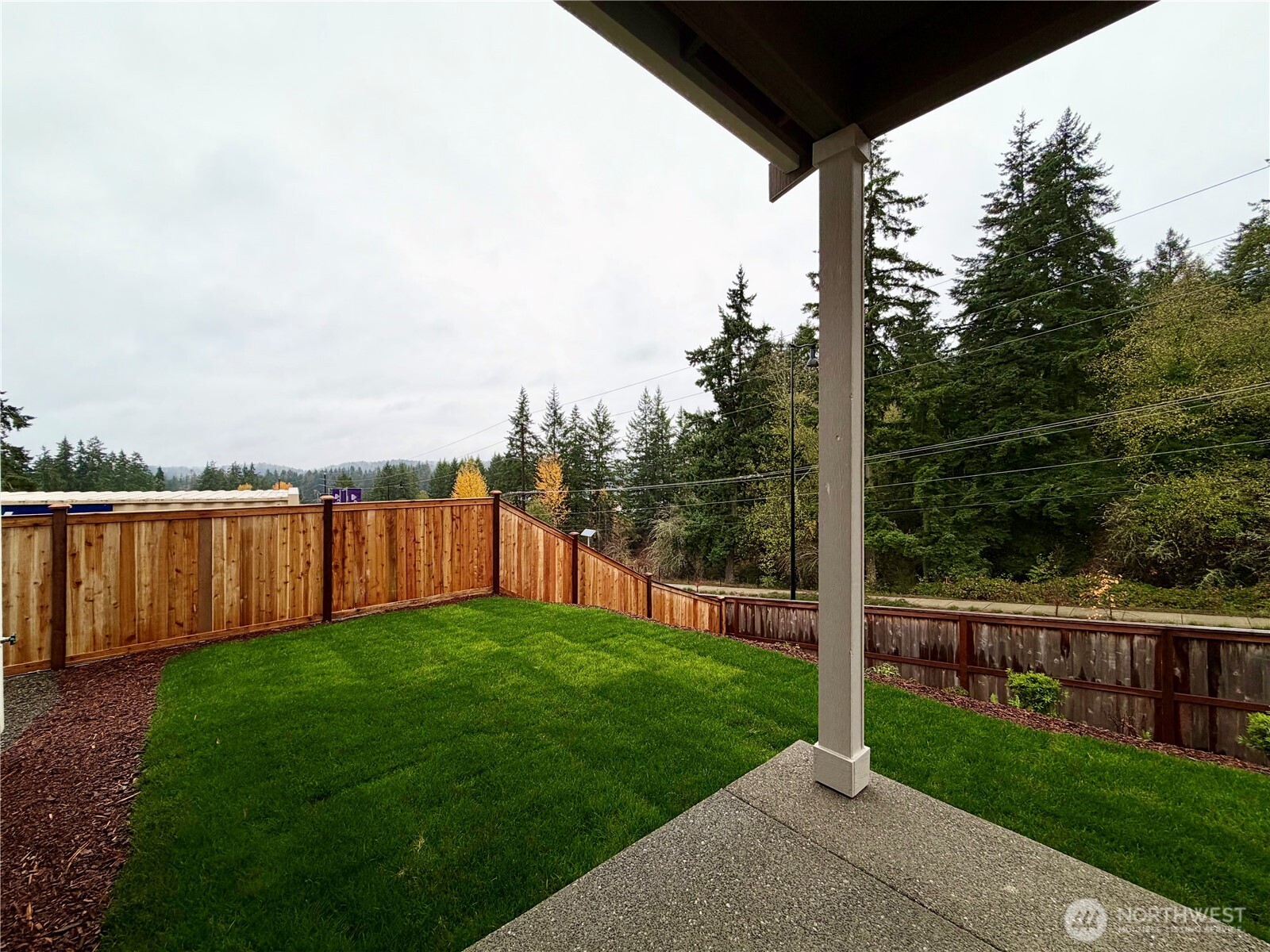 17529 Northeast Midnight Sun Loop Poulsbo, WA 98370 - Photo 8 of 36 a view of a yard with wooden fence