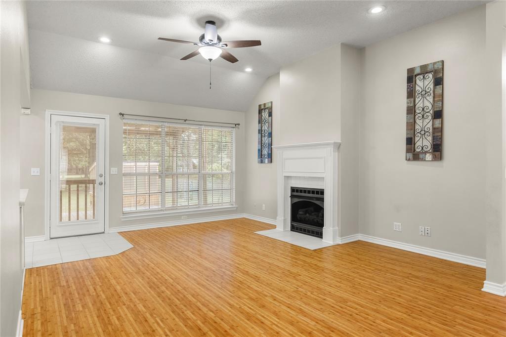 2917 Harlow Road Commerce, TX 75428 - Photo 5 of 40 a view of an empty room with a fireplace and a window
