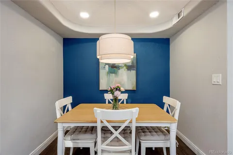 a dining room with furniture a window and wooden floor