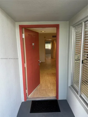 a view of a hallway view with wooden floor and windows