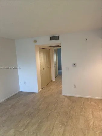 a kitchen with a cabinets and white appliances