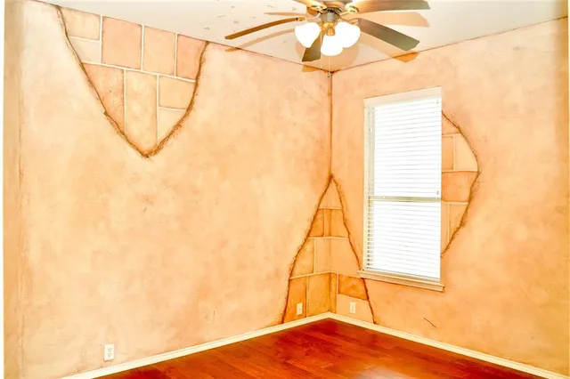 a view of a room with a window and wooden floor