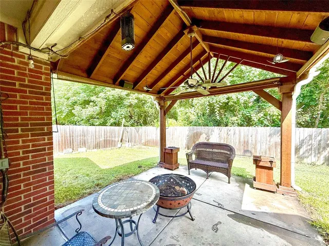 a backyard of a house with yard and outdoor seating