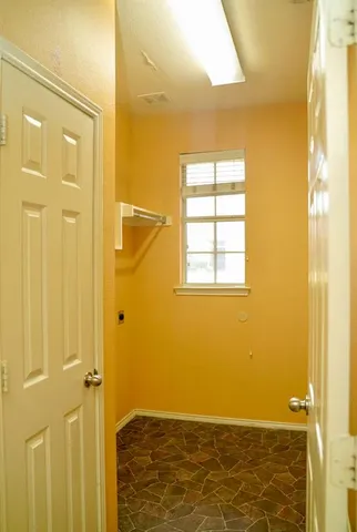 a view of bathroom with shower and a window