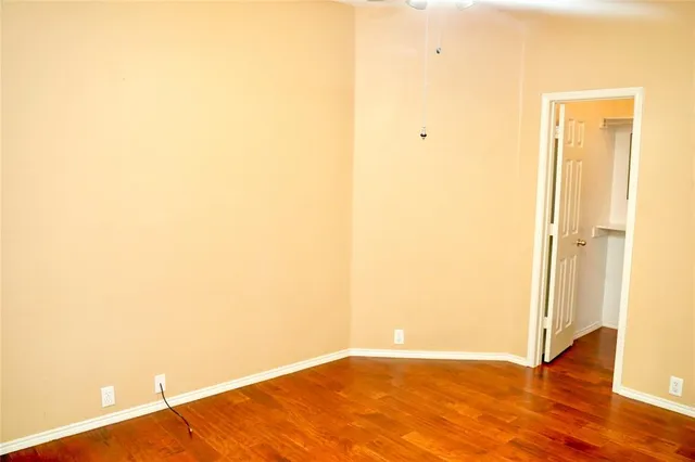 a view of a room with wooden floor