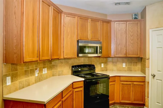 a kitchen with a stove and a refrigerator