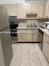 a kitchen with stainless steel appliances kitchen island granite countertop a sink and a stove