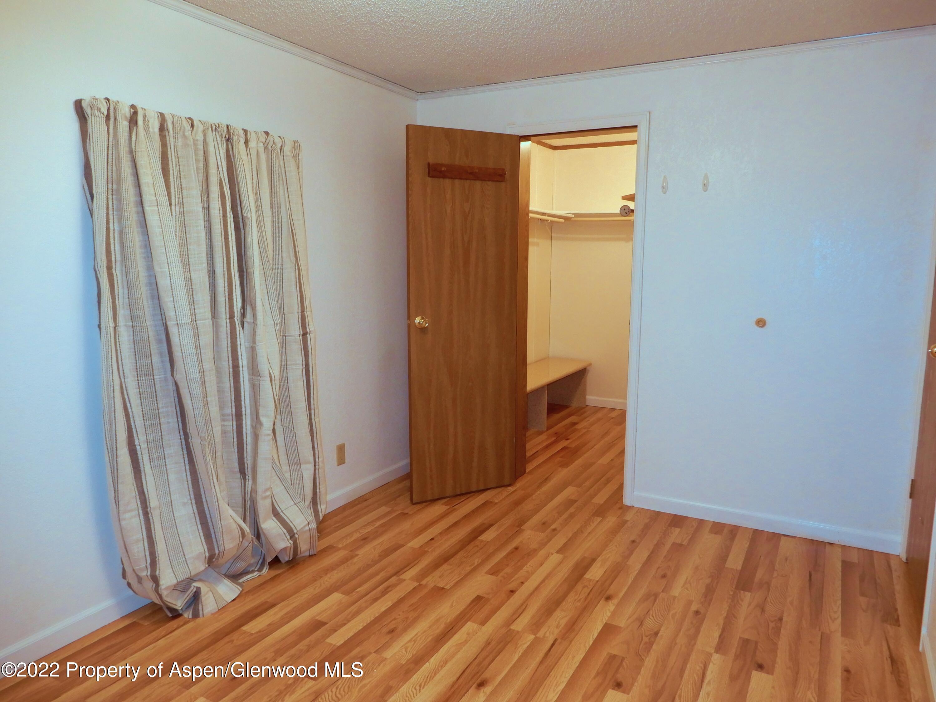 1110 Arnold Court Rifle, CO 81650 - Photo 12 of 23 a view of a room with wooden floor and a window