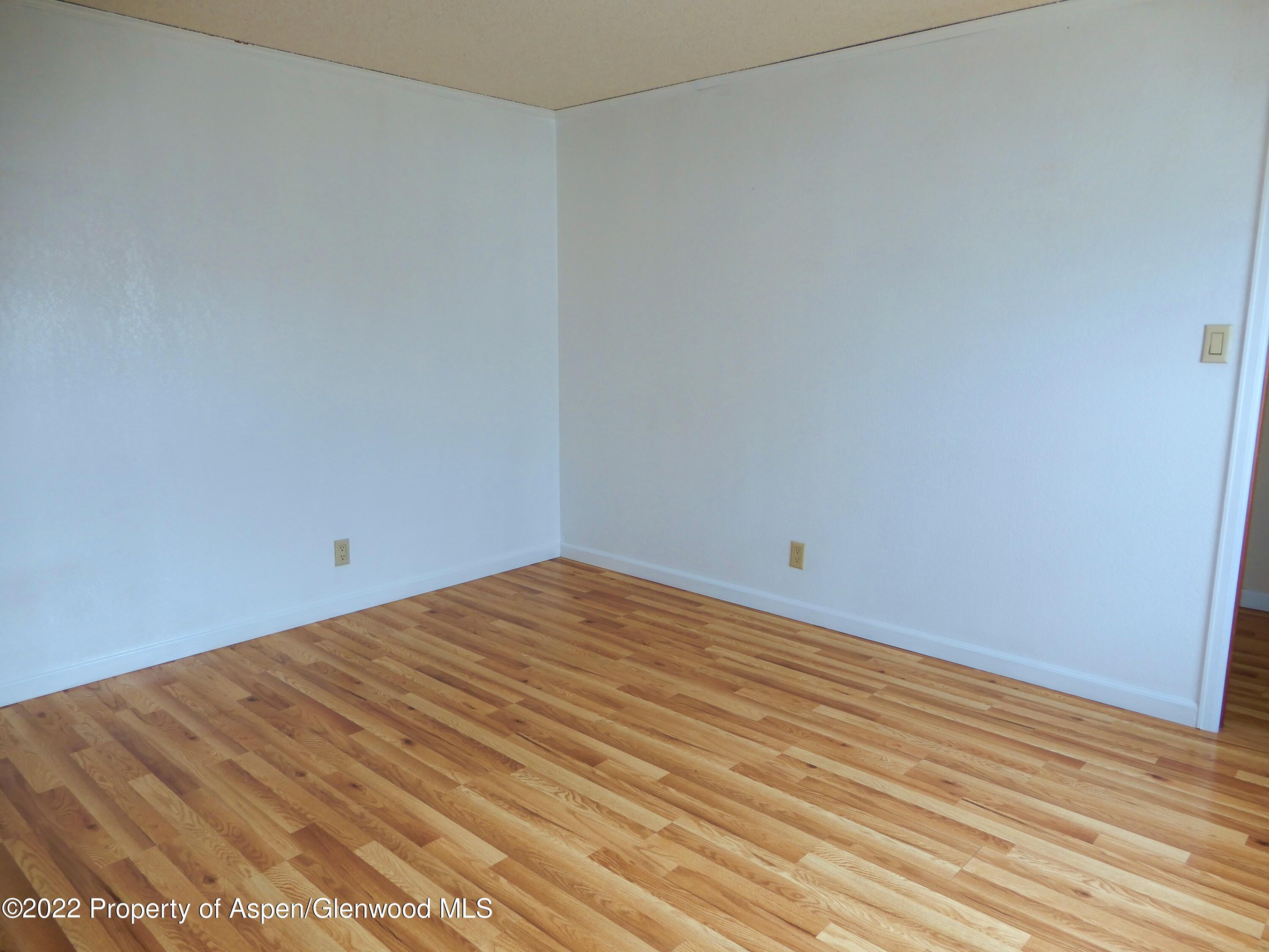 1110 Arnold Court Rifle, CO 81650 - Photo 15 of 23 a view of a room with an empty space and wooden floor