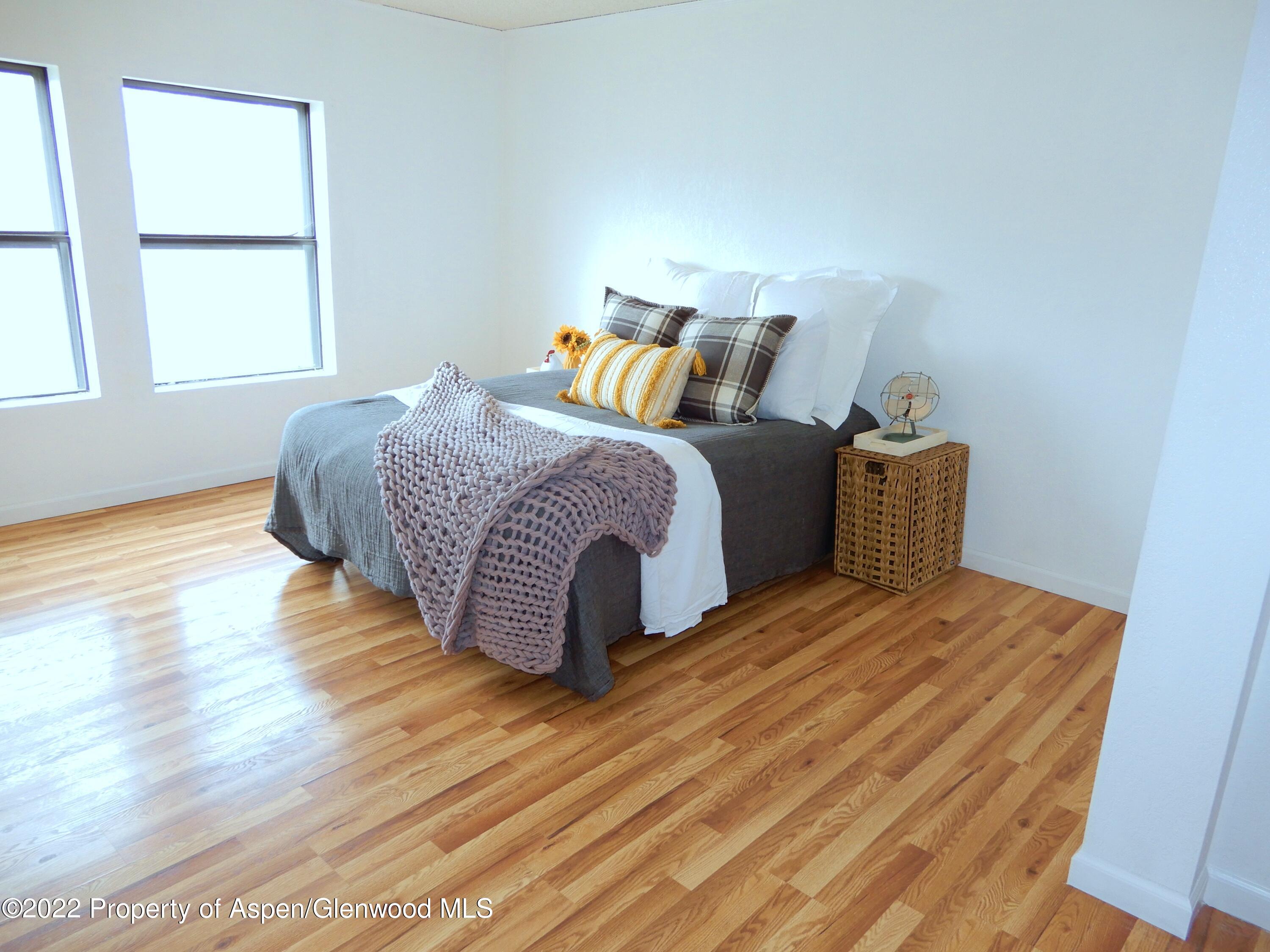 1110 Arnold Court Rifle, CO 81650 - Photo 17 of 23 a bedroom with a bed and wooden floor