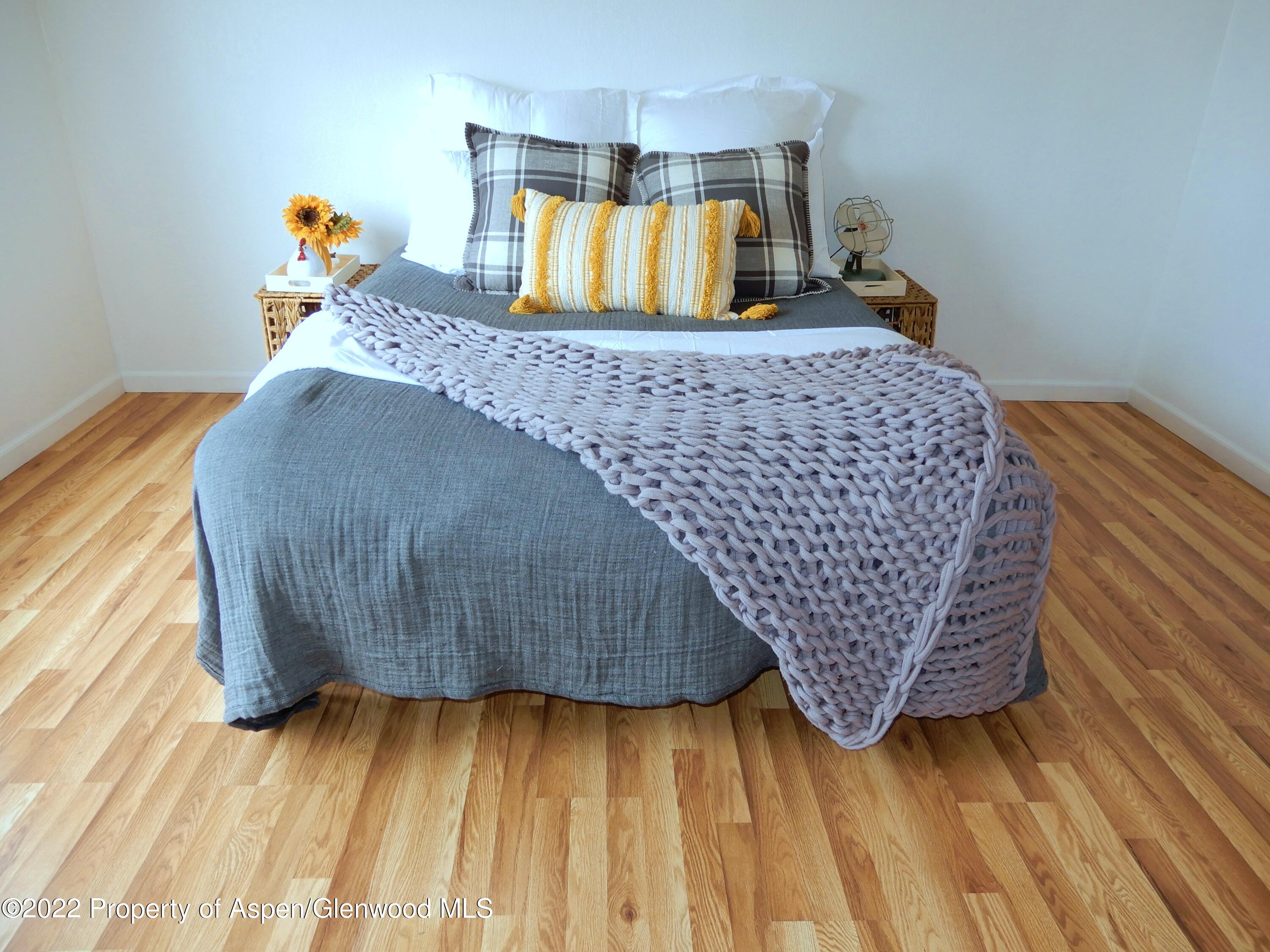 1110 Arnold Court Rifle, CO 81650 - Photo 18 of 23 a bedroom with a bed and wooden floor