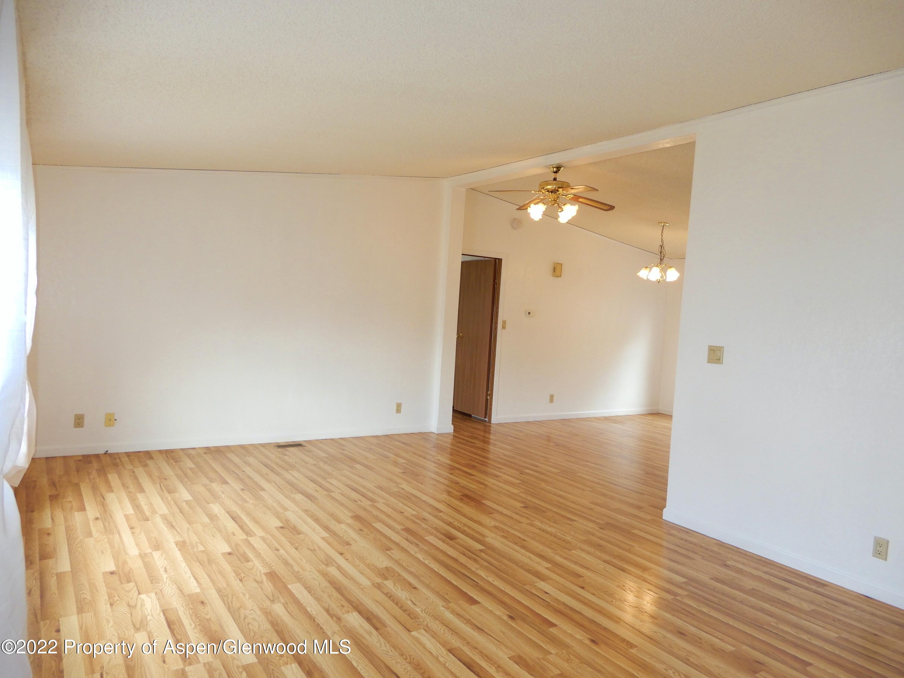 1110 Arnold Court Rifle, CO 81650 - Photo 4 of 23 a view of an empty room and wooden floor