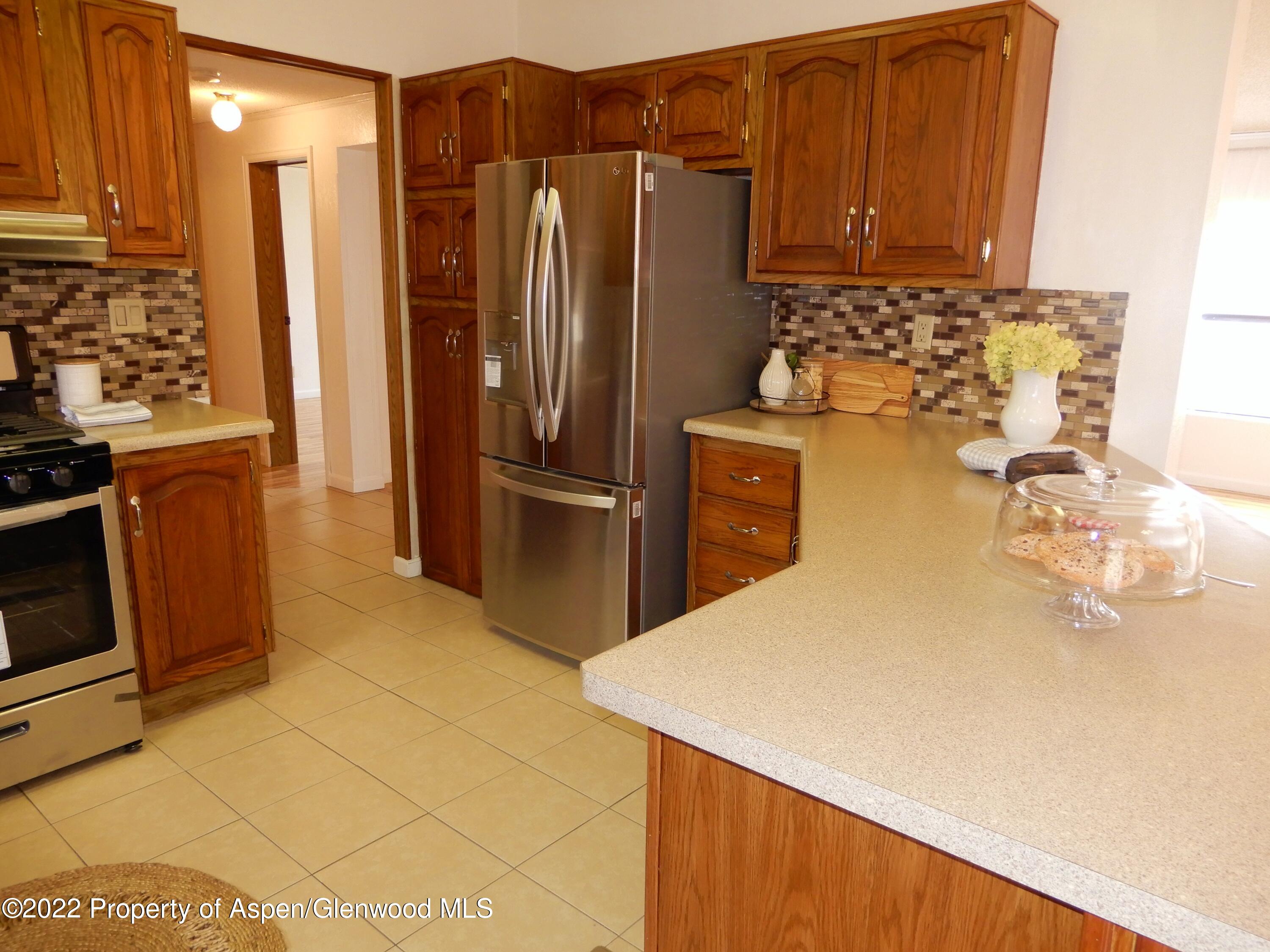 1110 Arnold Court Rifle, CO 81650 - Photo 10 of 23 a kitchen with stainless steel appliances a refrigerator and a stove