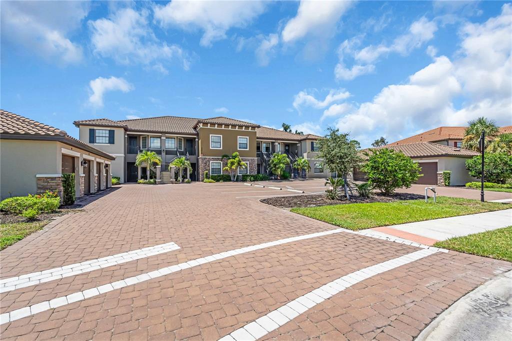 12413 Osorio Court, Unit 101 Sarasota, FL 34238 - Photo 1 of 46 a view of building with yard