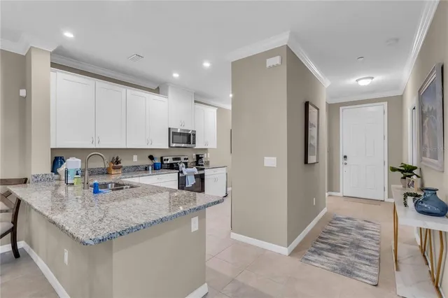 a kitchen with stainless steel appliances granite countertop a refrigerator and a sink