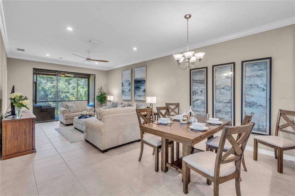 12413 Osorio Court, Unit 101 Sarasota, FL 34238 - Photo 12 of 46 a living room with furniture and a chandelier