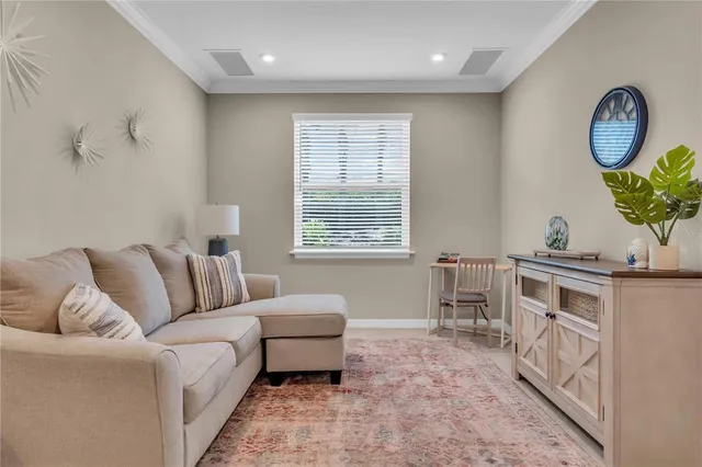 a living room with furniture a table and a window
