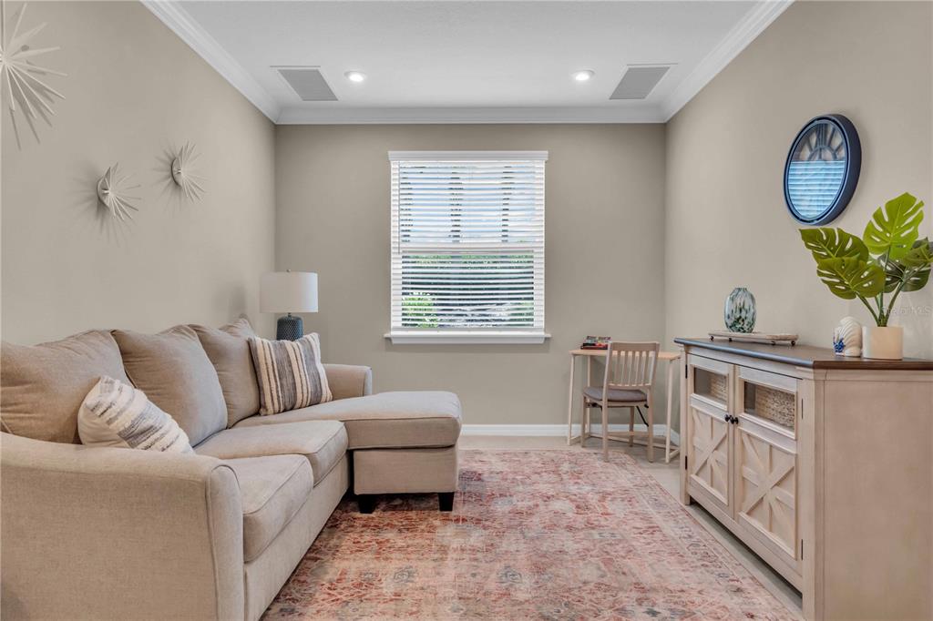 12413 Osorio Court, Unit 101 Sarasota, FL 34238 - Photo 15 of 46 a living room with furniture a table and a window