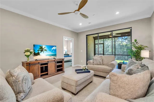 a living room with furniture a large window and a fireplace