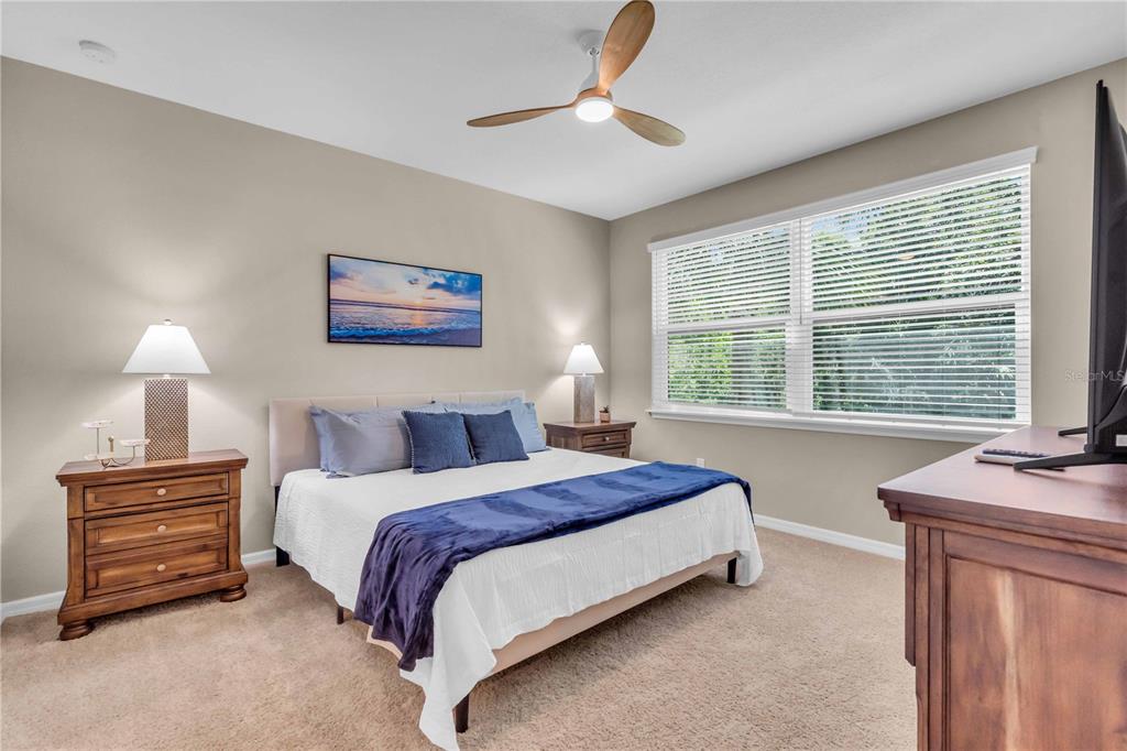 12413 Osorio Court, Unit 101 Sarasota, FL 34238 - Photo 20 of 46 a bedroom with a bed dresser and a window