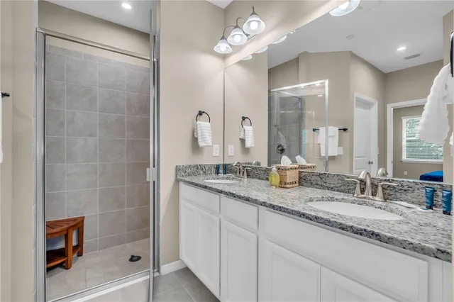 a bathroom with double sink and a mirror