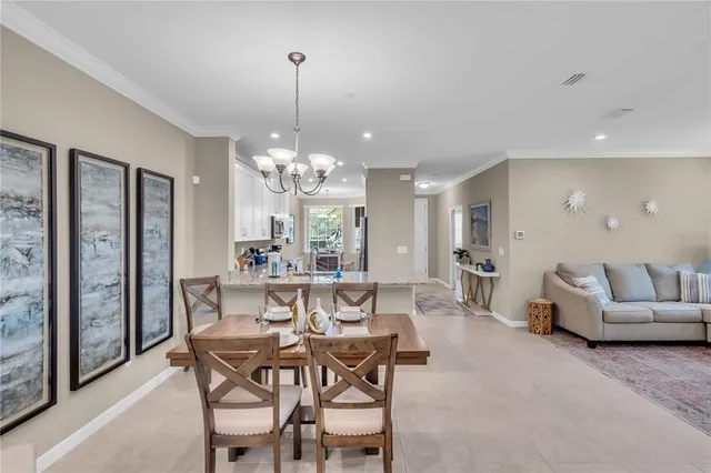 a view of a dining room with furniture and chandelier