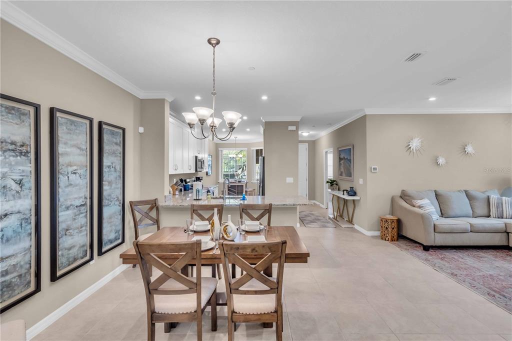 12413 Osorio Court, Unit 101 Sarasota, FL 34238 - Photo 24 of 46 a view of a dining room with furniture and chandelier