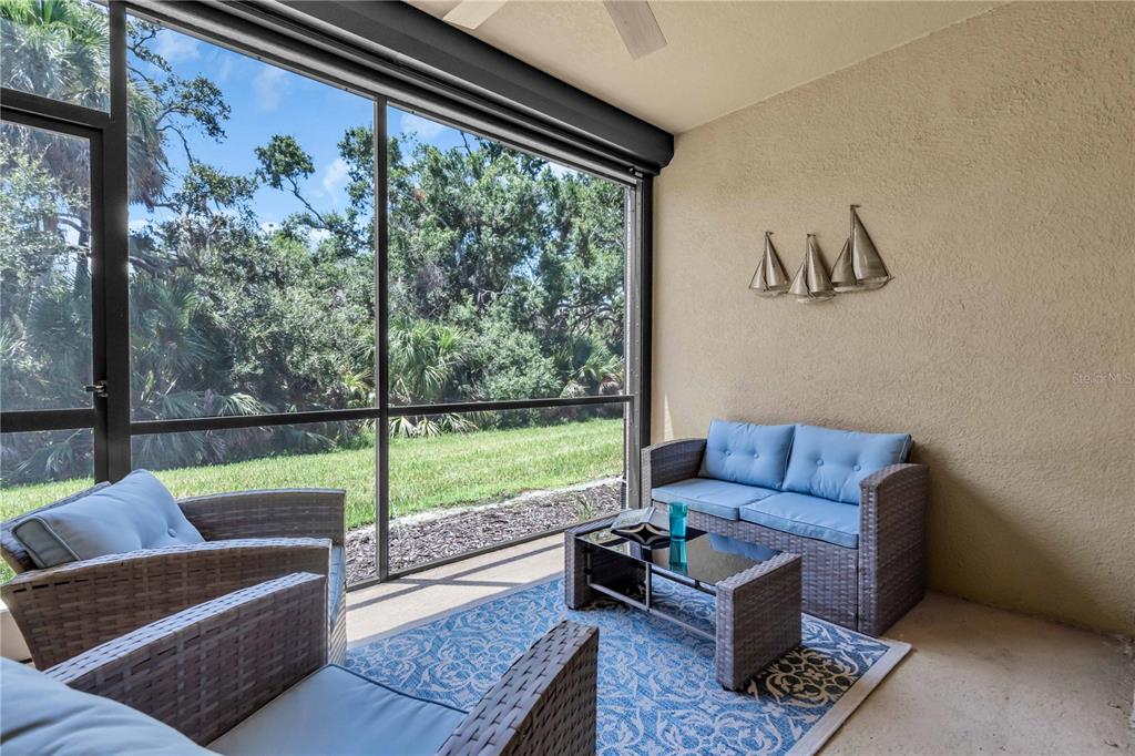 12413 Osorio Court, Unit 101 Sarasota, FL 34238 - Photo 25 of 46 a living room with furniture and a large window