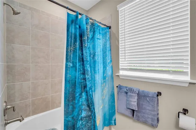 a bathroom with a shower and a bathtub